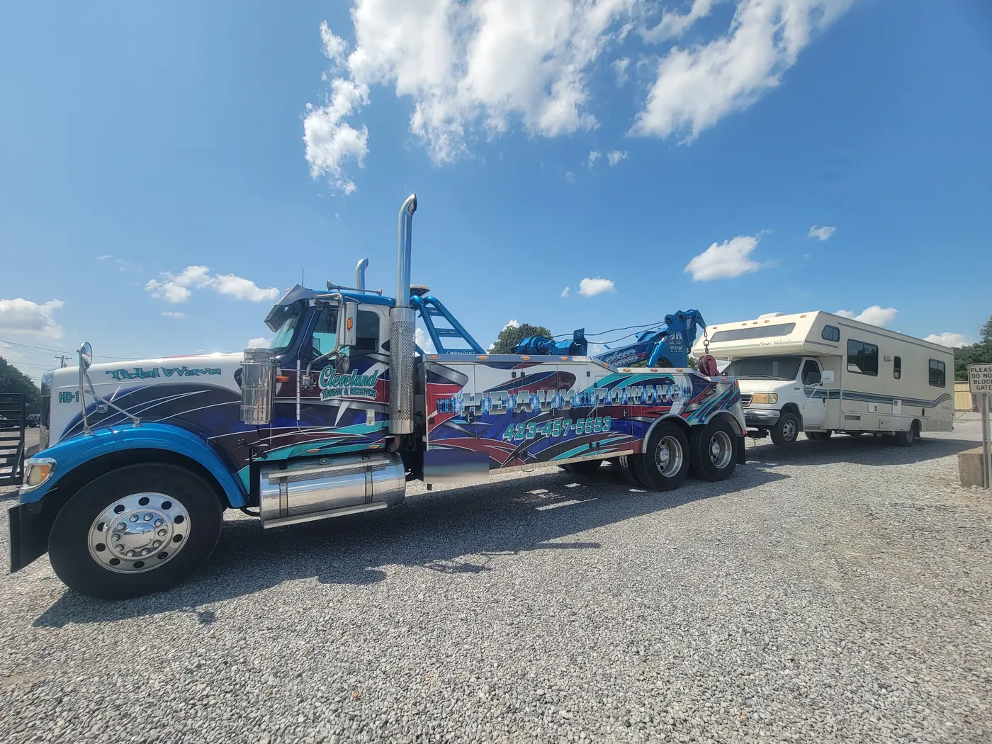 The heavy wrecker towing a Class C motorhome