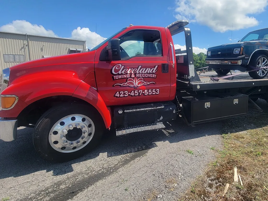 The cab of Cleveland Towing & Recovery’s red Ford rollback tow truck