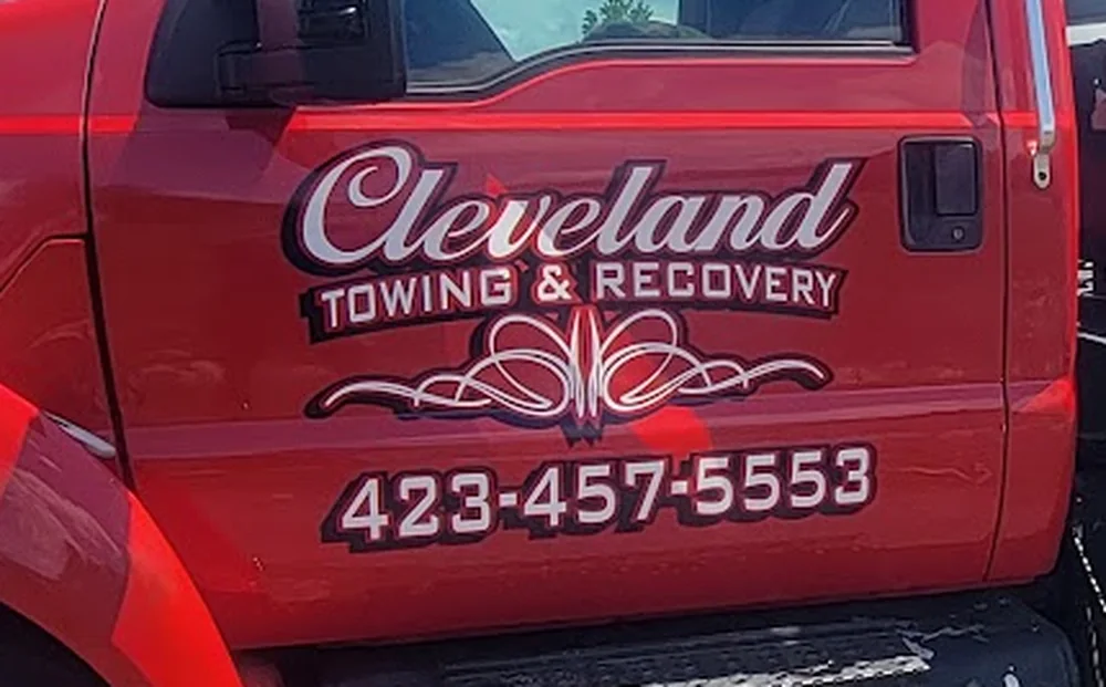 The Cleveland Towing & Recovery door decal on the truck, reading (423) 457-5553